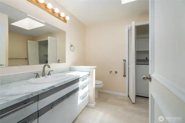 Full bathroom/laundry room. A skylight makes this room naturally shine.