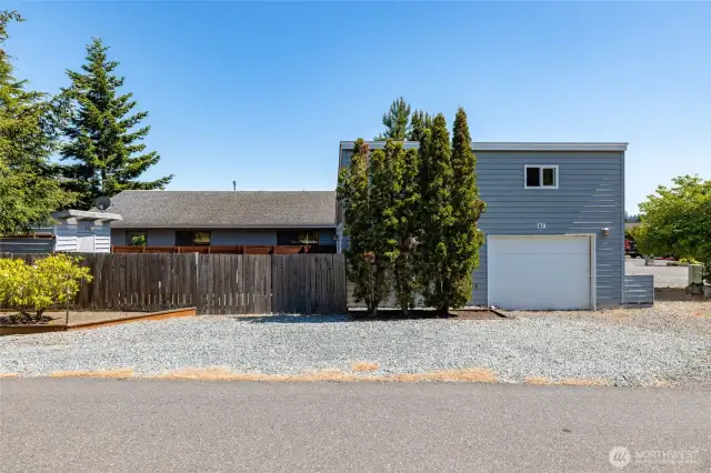 A potting shed to the left and gate access to backyard & office.
