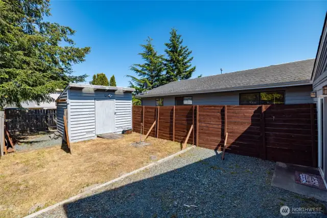 Potter's shed and temporary fence put up for once tenants who lived in home and the owner who used the office. Can be easily removed.
