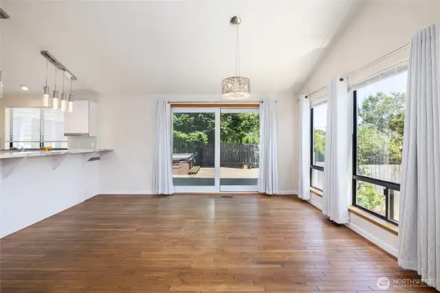 Hardwood floors, spectacular natural light, open-concept living room/dining area/kitchen.