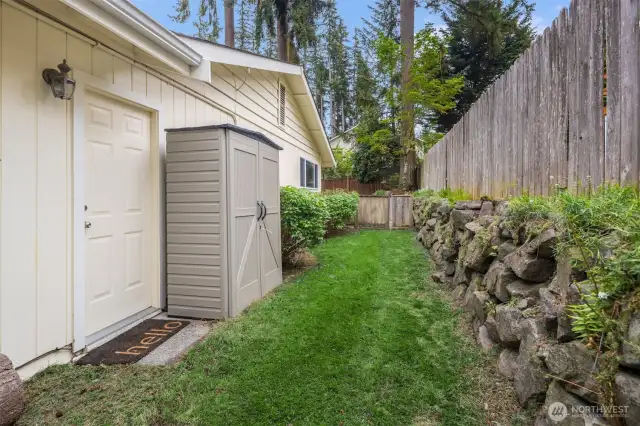Side yard with retaining wall & storage cabinet