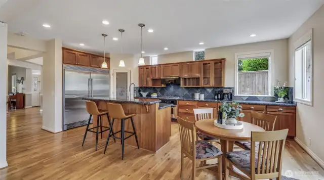 Gourmet kitchen features granite counters, cherry cabinets, slate backsplash, SS appliances w/60” wide Refrigerator.