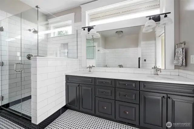 Recently remodeled primary bath with new quartz counters and tile shower.