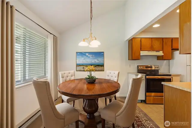 Dining room virtually staged next to kitchen