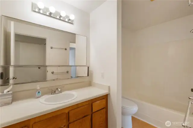 full bathroom with combo tub/shower mirrored storage area