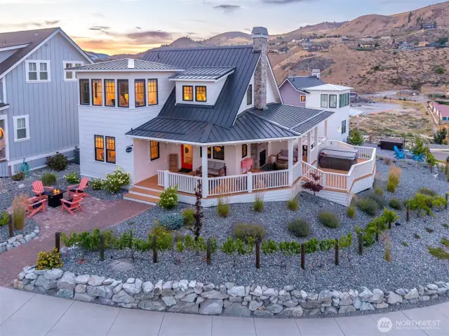 Exterior view 1 of home with wraparound porch and outdoor living area.