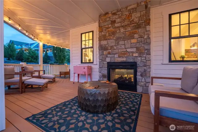 View of outdoor living area with double sided fireplace.