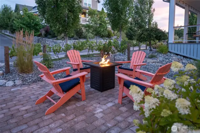 Exterior twilight view of outdoor fire pit.
