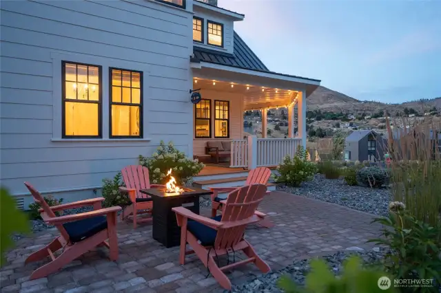 Exterior twilight view of home and outdoor fire pit area.