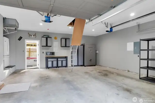 Garage has a drop down ladder accessing additional storage space