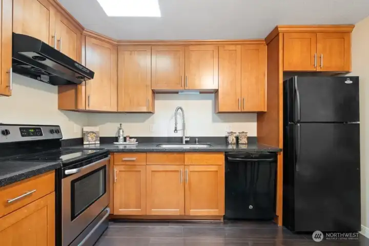 Updated kitchen with granite and custom cabinets.