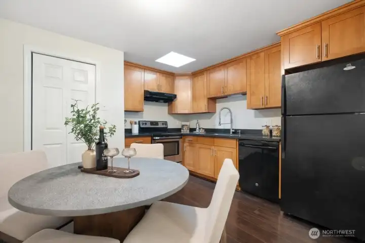 Open eat-in kitchen with pantry and newer skylight