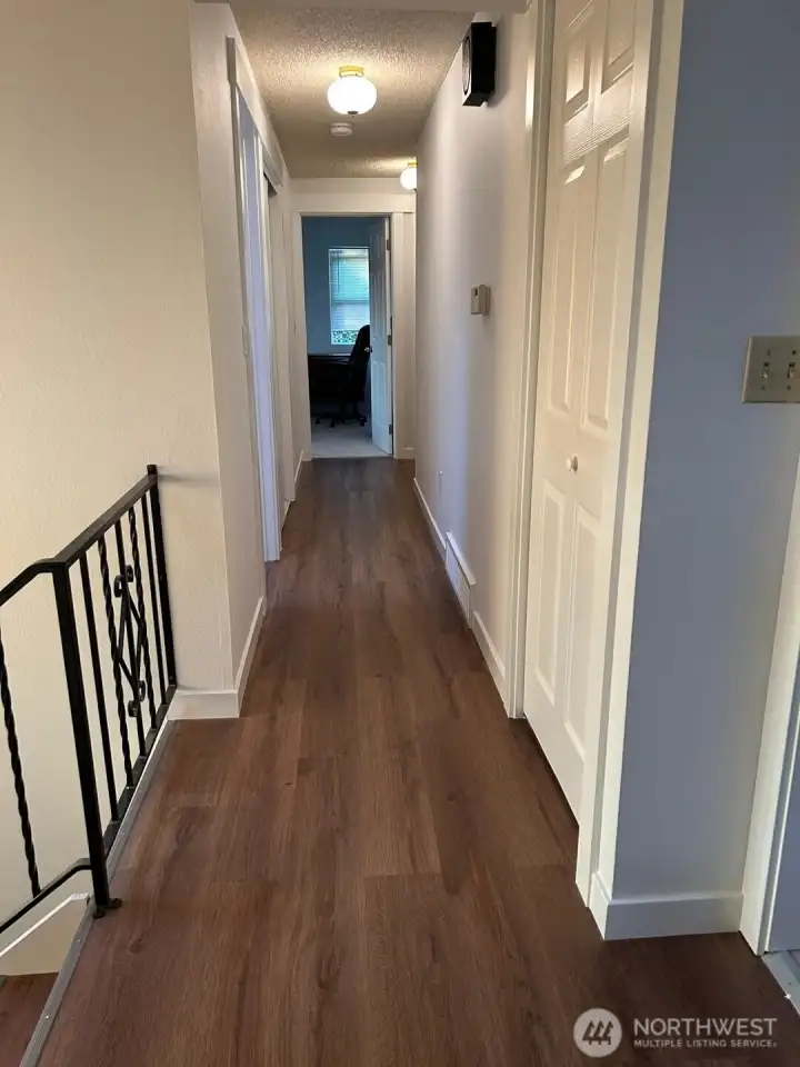 Upper level hallway with new floor and closet doors
