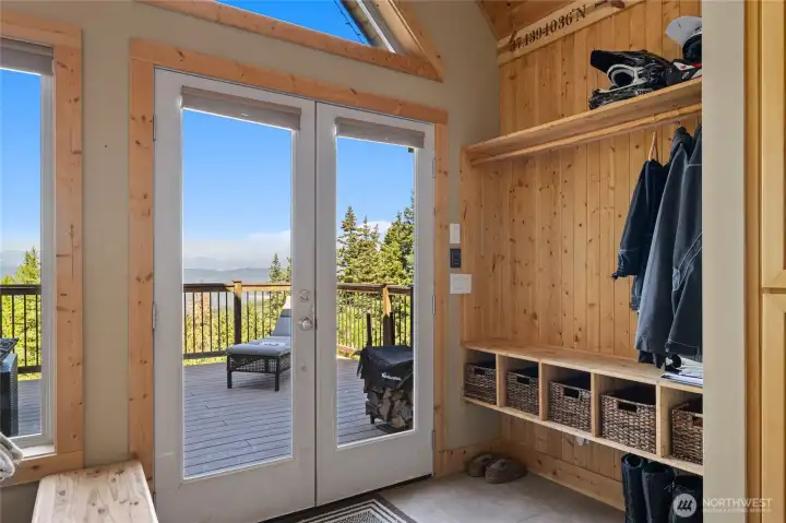 Tiled entry with coat rack and storage area.