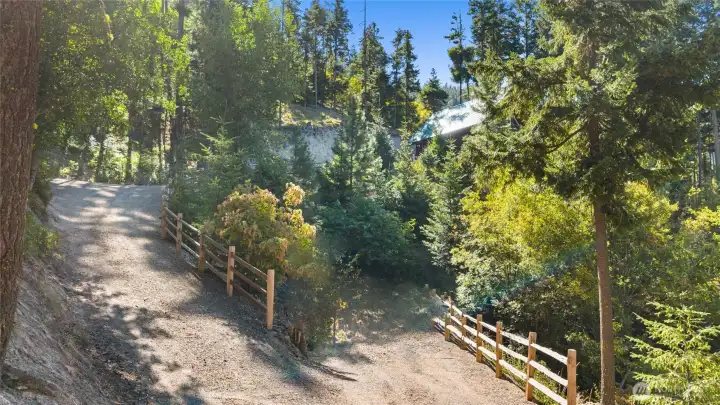 Driveway with split rail fence.