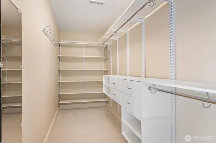 The primary suite is complete with dual walk-in closets—designed so both partners have their own spacious storage.