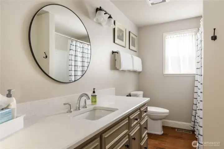 Main-level full bath featuring a spacious linen closet