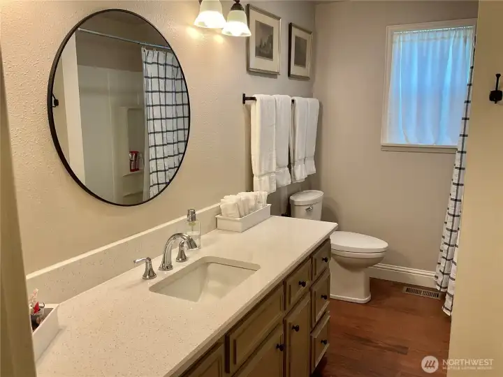 Main-level full bath featuring a spacious linen closet