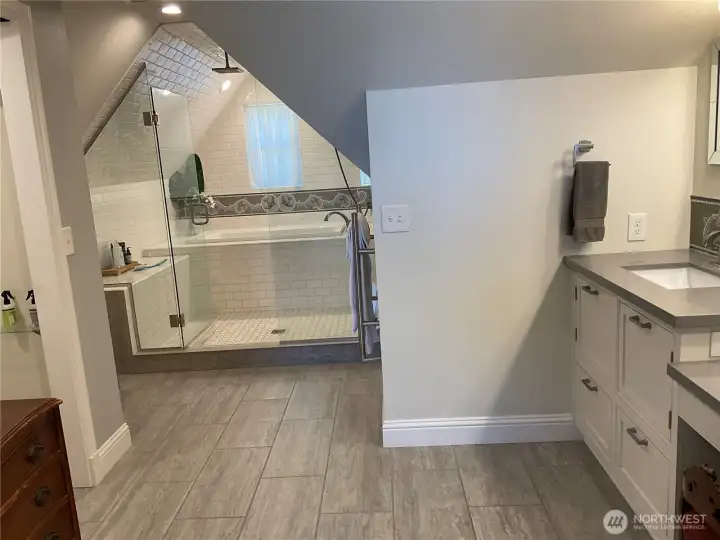 Spacious primary bathroom with convenient built-in laundry chute