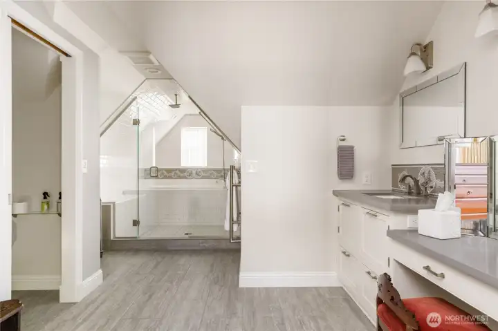Spacious primary bathroom with convenient built-in laundry chute