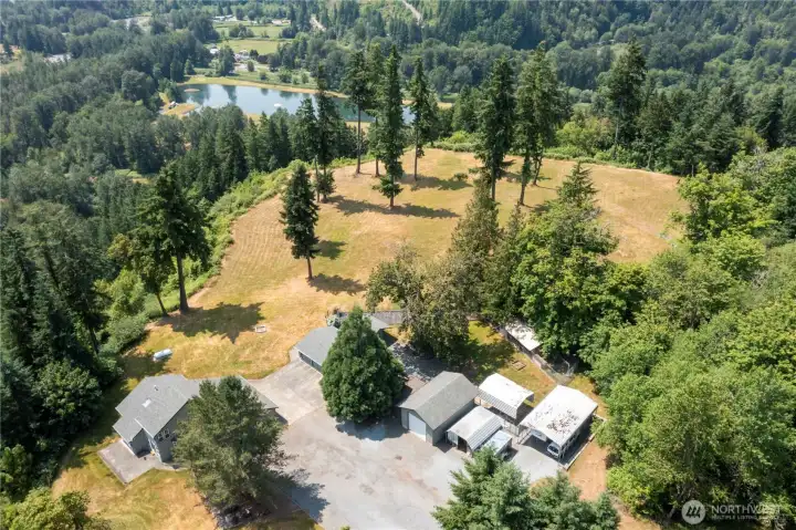 This an aerial shot that captures the home (lower left corner of photo), all outbuilding structures.