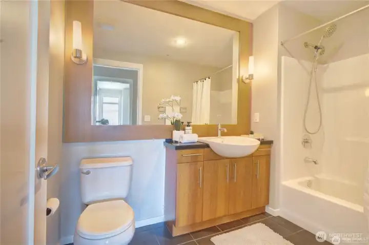 Large Bath with Mahogany Cabinets and Mirror.
