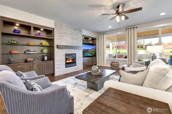 This beautifully designed open-concept home features a stunning great room with custom built-ins and a floor-to-ceiling stone fireplace.