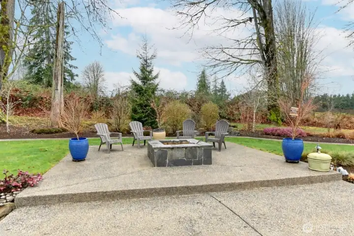 Private outdoor gathering space with a built-in firepit and ample seating—perfect for year-round entertaining