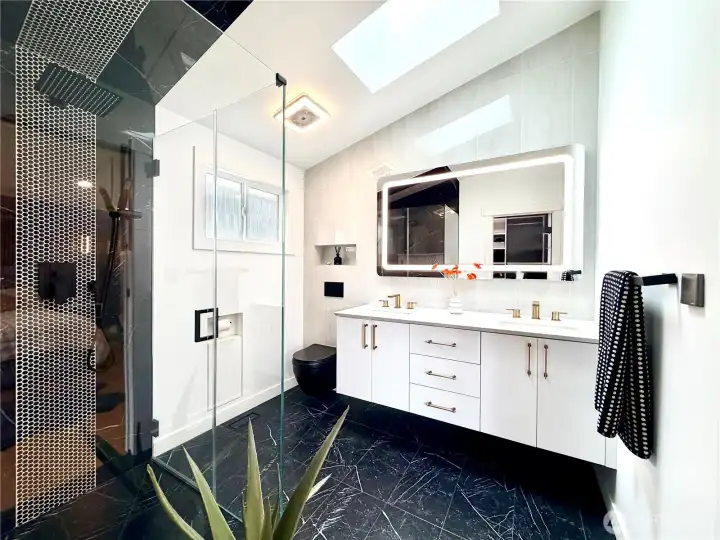 Fully remodeled bathrooms with quartz countertops and frameless glass shower doors