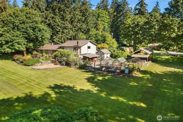 The sun-drenched lawns, huge patio, fenced veggie gardens, two greenhouses and carport; it's all here!