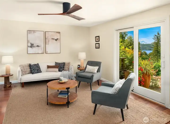 Family room opens onto the paved patio with south side lawns and gardens beyond.