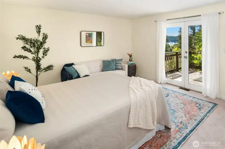 Primary en-suite bedroom has big walk-in closet and its own private, south-facing balcony. Fresh carpet and paint, too.
