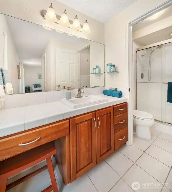 Primary bath with walk-in shower and tiled floor.