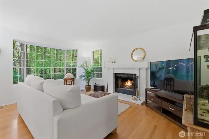 Light filled living room with wood burning fireplace