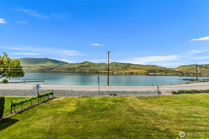 Extending from the patio is this huge, level lawn perfect for outdoor games. No worries if the parking lot is full, just step across the road and you're there!