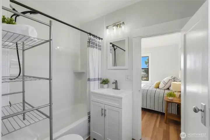 Updated bathroom features convenient dual-entry access from both bedrooms, creating a functional shared layout. Updated bathroom features convenient dual-entry access from both bedrooms, creating a functional shared layout.