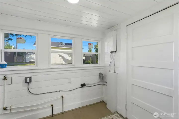 Mudroom off the kitchen serves as a laundry room and utility space with new windows. Mudroom off the kitchen serves as a laundry room and utility space with new windows.