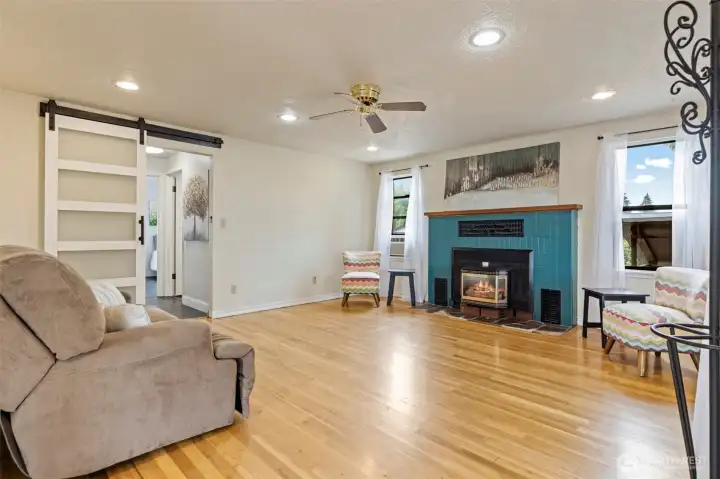 Living room with gas fireplace and oak floors