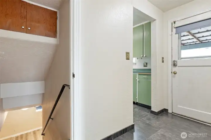 Hallway to either go downstairs, through the kitchen, or outside to the side patio