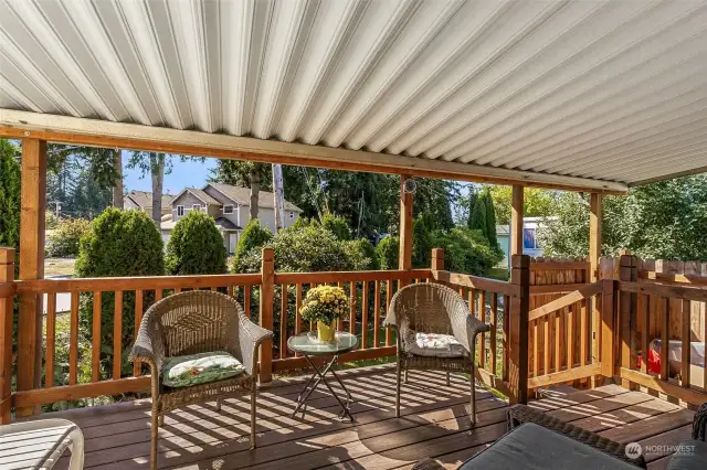 Lovely covered deck area off the kitchen to enjoy relaxing and having a BBQ.