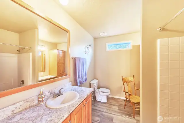 Large full bathroom with built-in dressing table and shelves