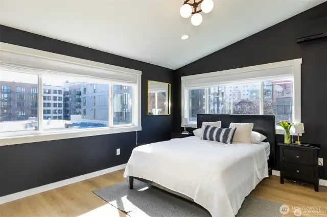 Primary bedroom with vaulted ceilings.