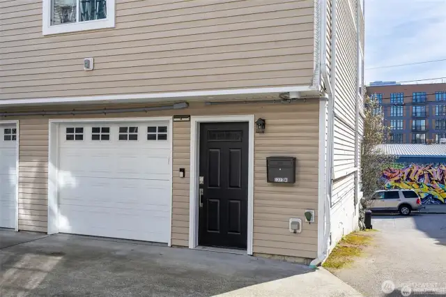 Single car garage with extra storage and laundry.