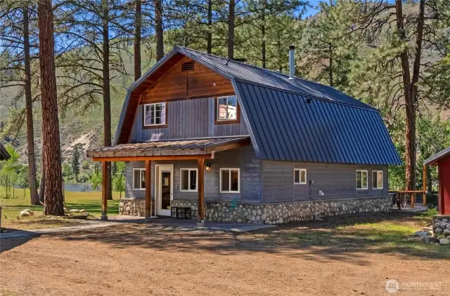 Updated home flanked by pines, Methow River, root/wine cellar, rec bld, & many outbuildings 4.3 acres.