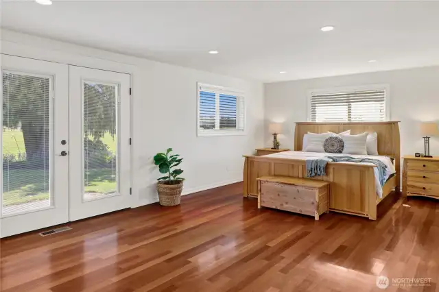 The primary suite is so spacious and has access to the backyard and hot tub