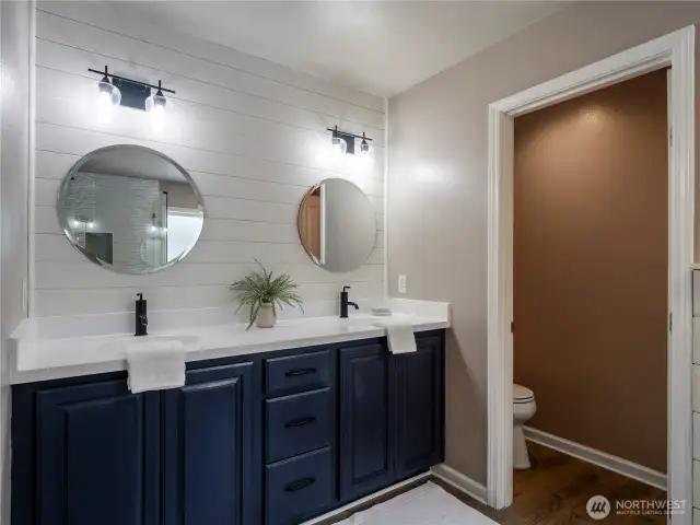 Dual vanities and water closet.