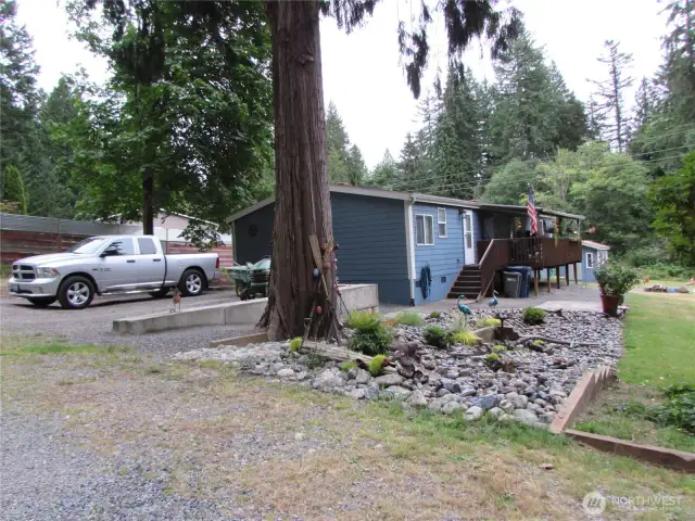 Off Bunk Foss Rd. a short private driveway is shared w/ Northern neighbors' home, Raised Parking area w/ walkway to gated, covered deck and Lots of southern exposure. Peaceful setting.