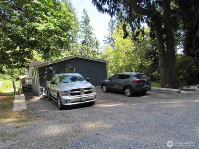 Front door to Left (back door here) has enclosed cyclone fence for dog run (Ideal set up). Homes main entry to right on gated covered deck.
