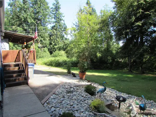 Walkway from parking area leads to main entry, afternoon sun covers part of Yard.