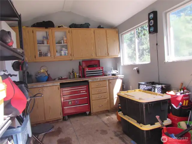 Insulated shop w/ power provides space to work on small projects w/ room to store them too. Shelf to left goes with Seller.